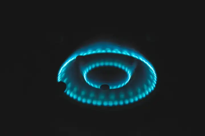 Ring of blue gas flame burning in the dark